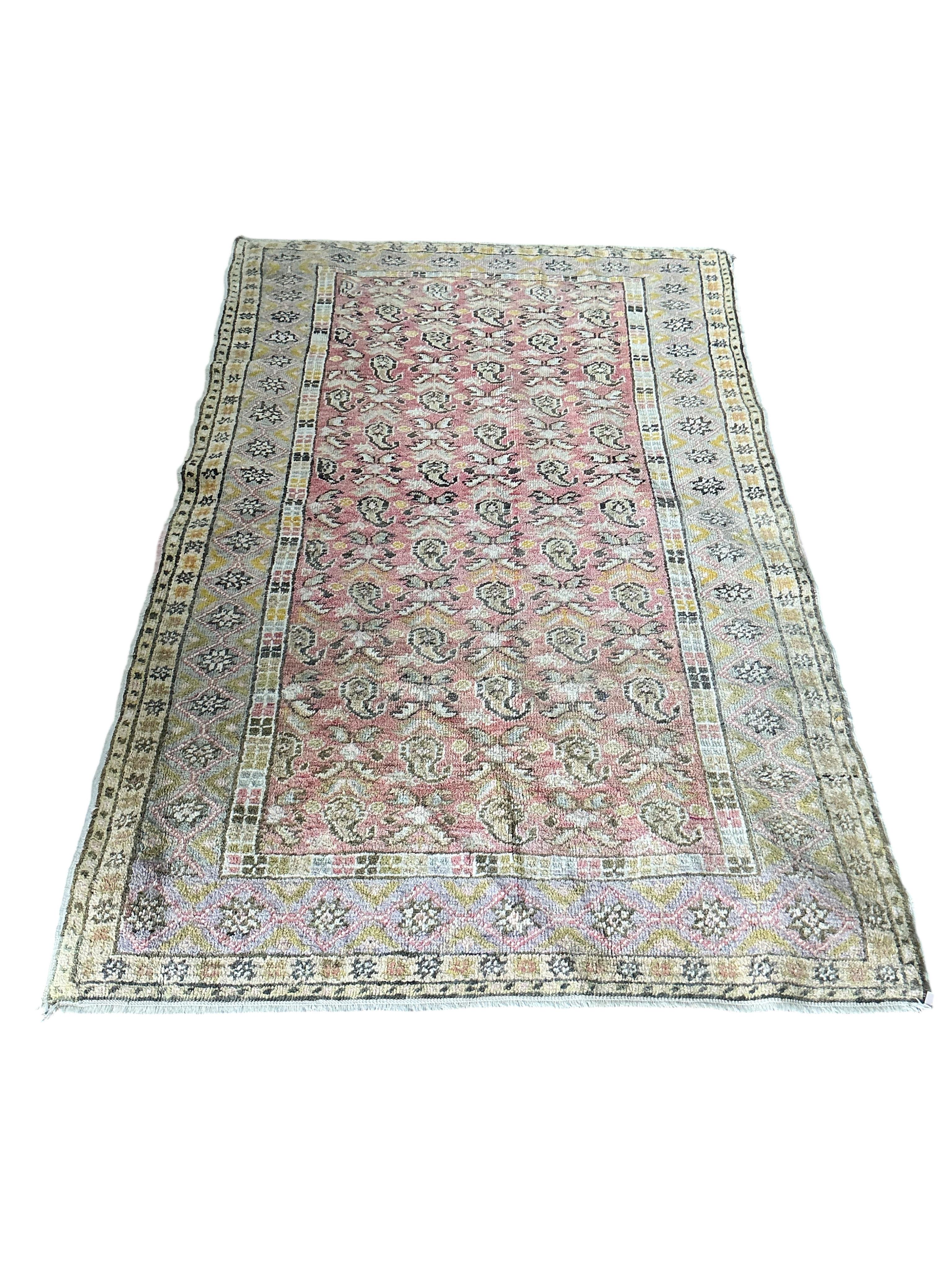 A Turkish pale red ground boteh rug, 194 x 158cm